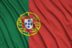 Portugal flag is depicted on a sports cloth fabric with many folds. Sport team waving banner